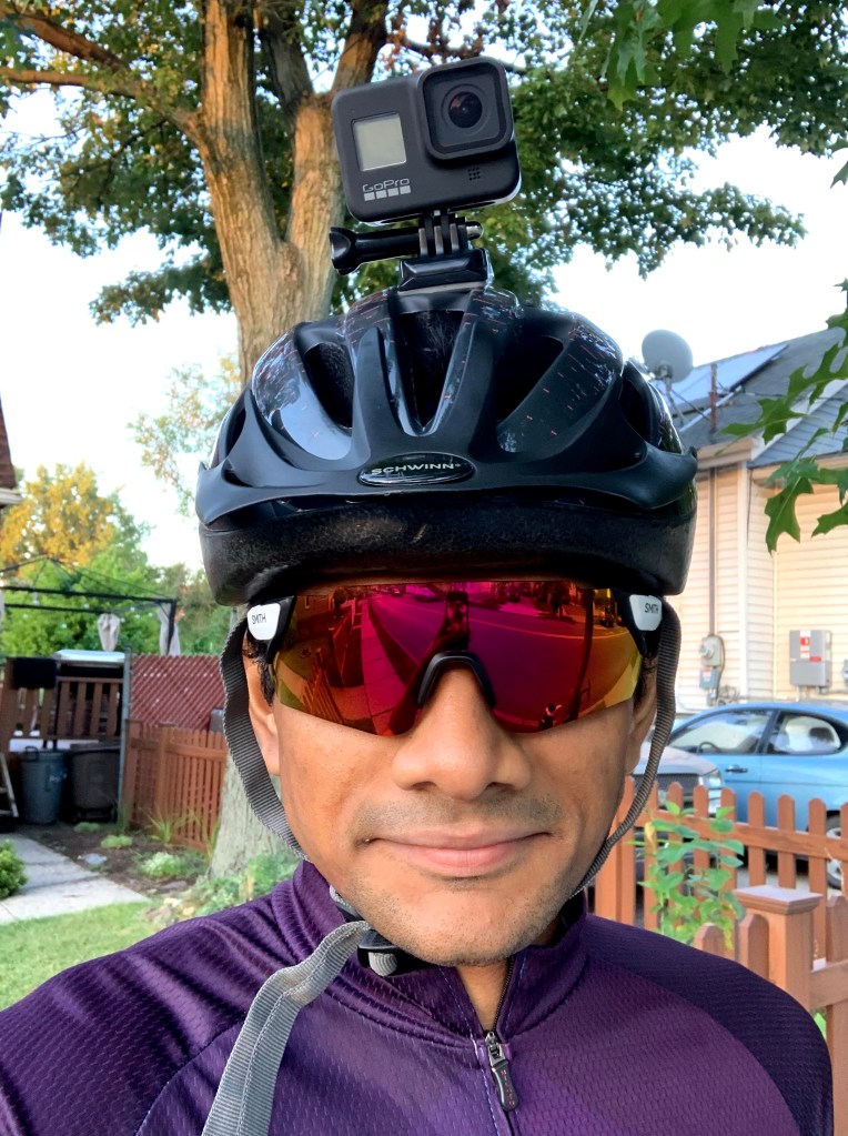 Yeswanth wearing a cycling helmet and sunglasses